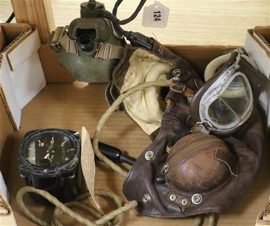 A WWII pilots flying helmet and a Smiths altimeter MKXVIIA from a Lancaster bomber